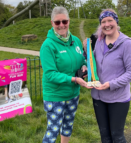 Marie and Abi pose wih Wythall Fun Run medals