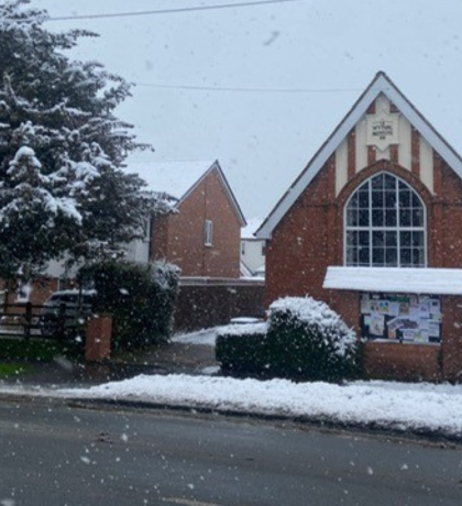 Wythall Village Hall with snow on its roof and and laying on the ground
