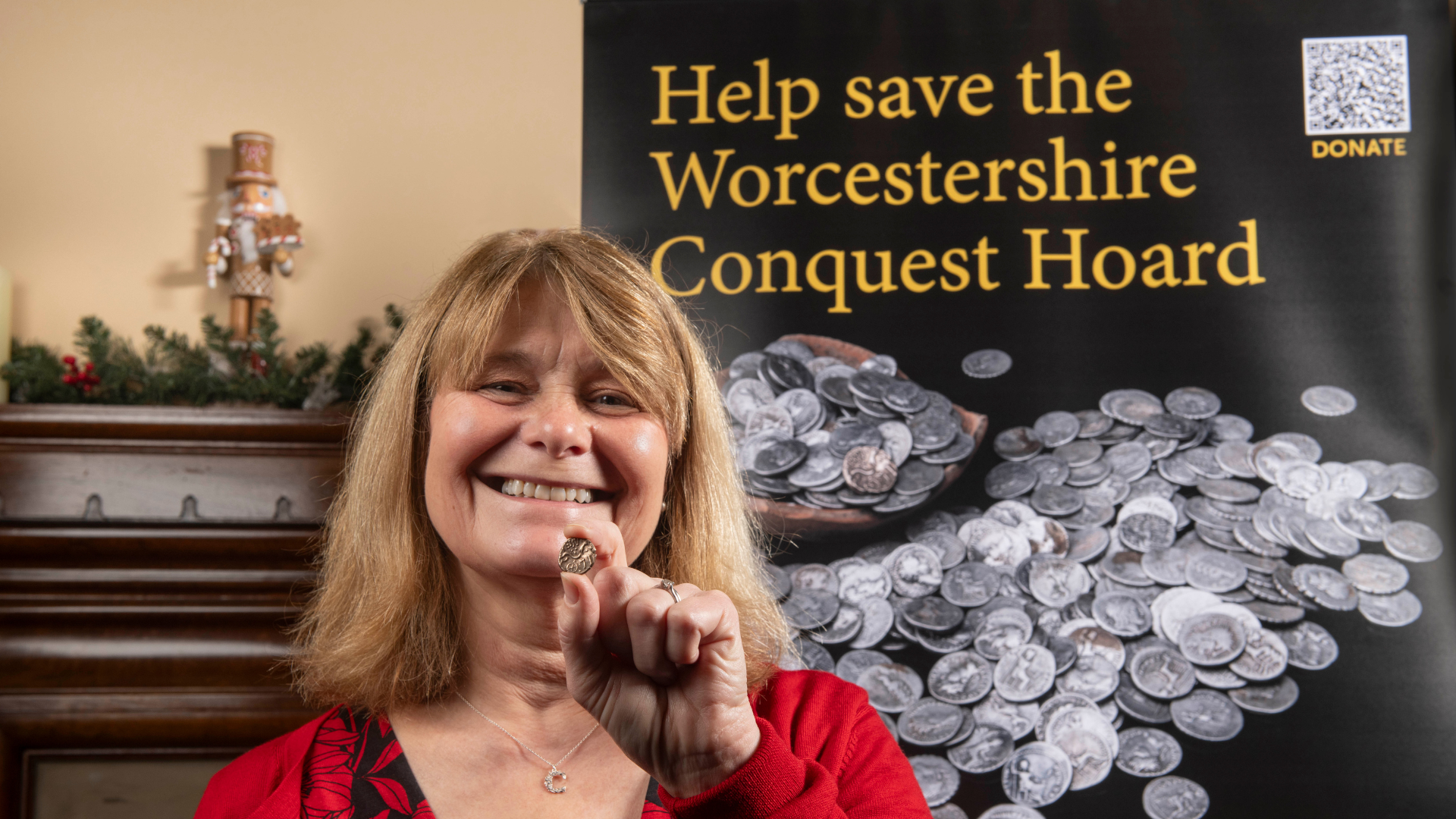 Chair of WHAM Caroline Naisbitt points at screen that reads Help save the Worcestershire Conquest Hoard.