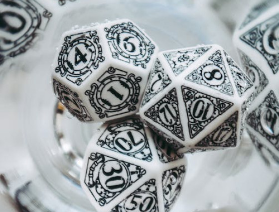 Close up shot of white dungeons and dragons dice in a glass