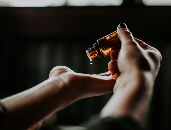 Image of a person dropping essential oils onto their hand