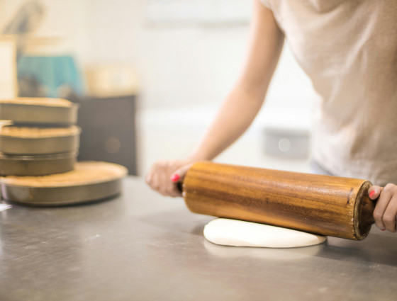 Image of a person using a rolling pin