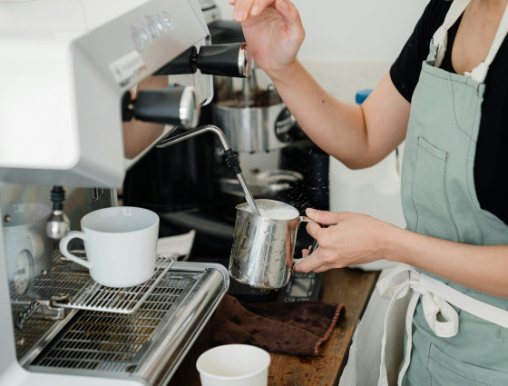 Image of a person using a coffee machine