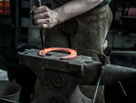 Image of blacksmith forging a horseshoe