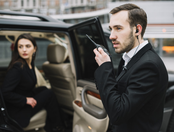 Image of a bodyguard using a walkie talkie