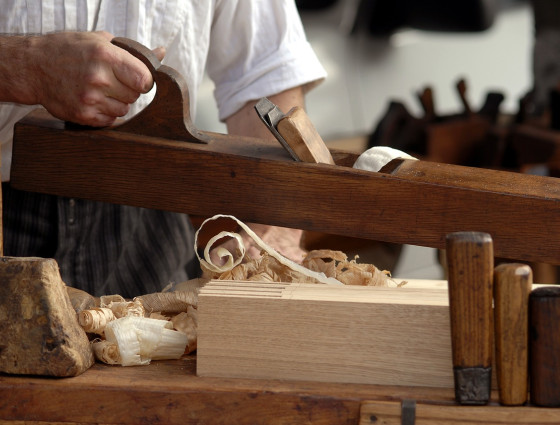 Image of a person working on a piece of wood