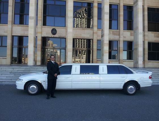 Image of a driver stood in front of a white car