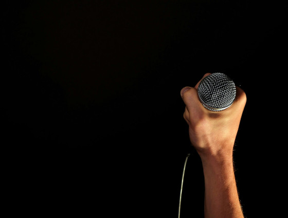 Image of a hand holding a microphone