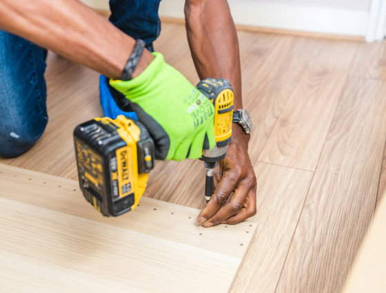 Image of a person using a powered screwdriver