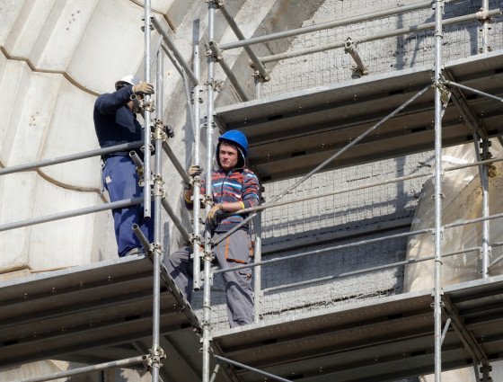 Image of two people working at height on scaffolding