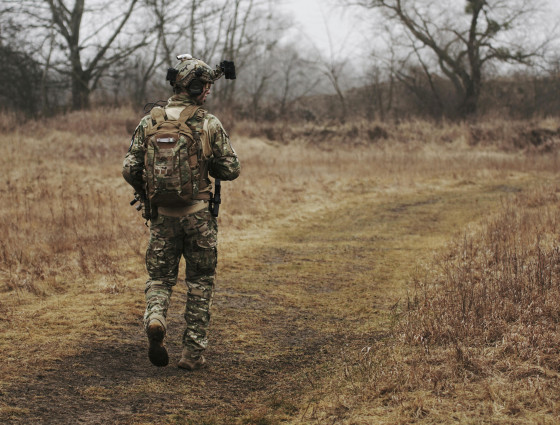 Image of army soldier walking in a field