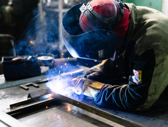 Image of a welder welding metal