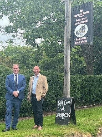 Cllr Kent and Cllr Bayliss outside Coach & Horses sign