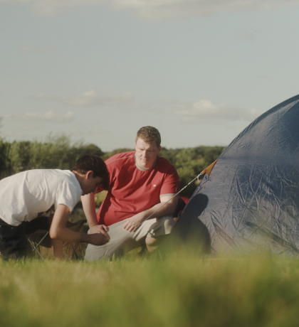 Children sitting outside a tent