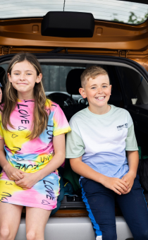 Children sitting in a car boot