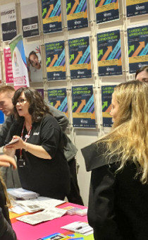 People interacting at a Careers Worcs booth during an event. 