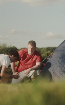 Children sitting outside a tent